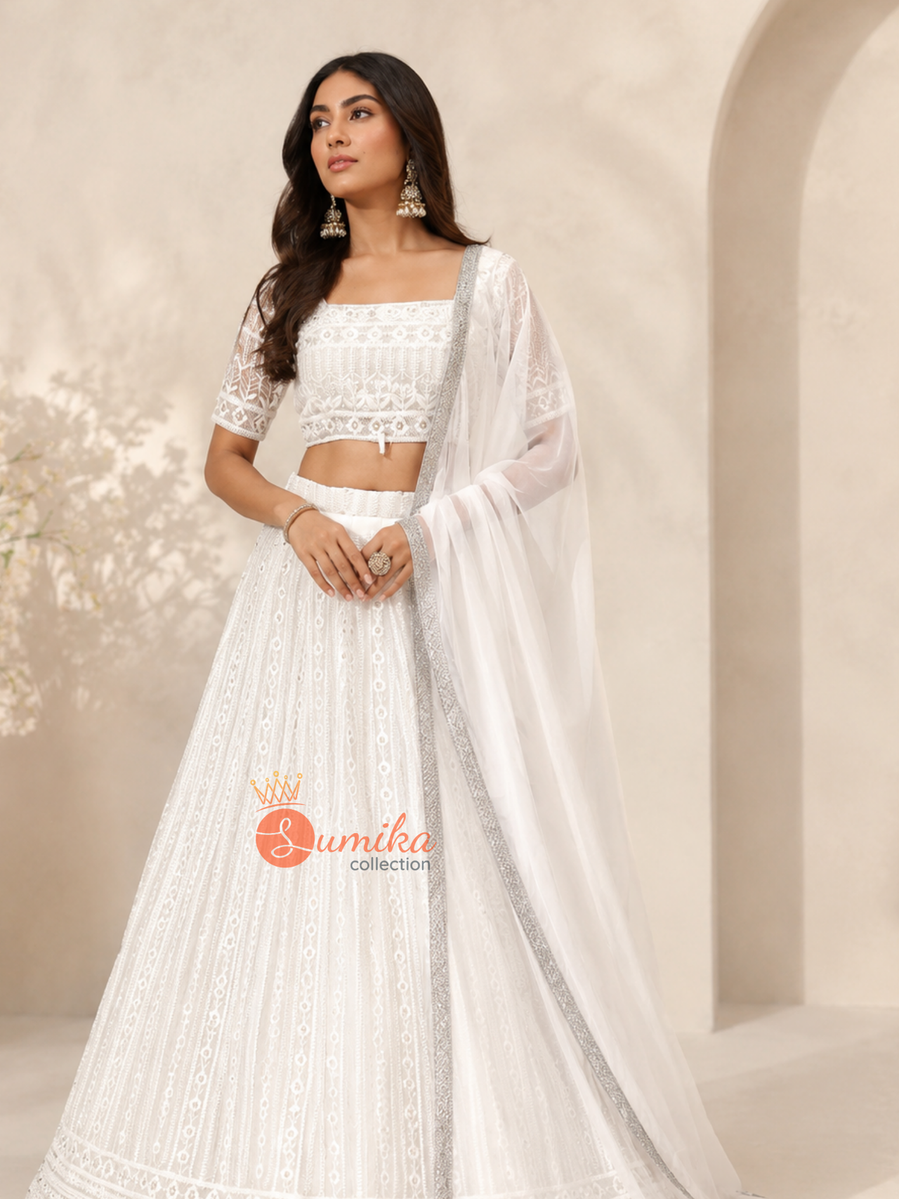 White Indian lehenga set with tonal embroidery, elbow-length sleeve blouse, and silver-bordered dupatta from Sumika Collection