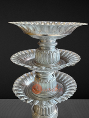 Traditional Nepali festival tika plate with gold or silver finish and decorative stand